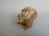 an image of a statue of a man ' s head on a table