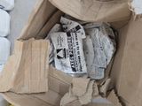 a cardboard box full of newspapers sitting on the floor