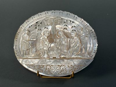 an antique silver plate with a scene of jesus and mary in the center
