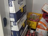 boxes of beer are stacked on top of each other in a refrigerator