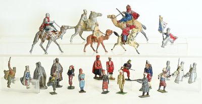 many figurines of people riding on horses and horses