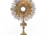 une image représentant un calice doré surmonté d'une croix