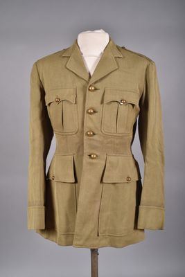 un uniforme militaire sur un mannequin, devant un fond gris