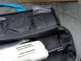 a blow dryer in a case on the ground