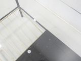 a person standing in a bathroom with a toilet in it