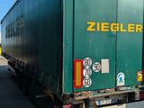a green semi truck that is parked on the side of the road