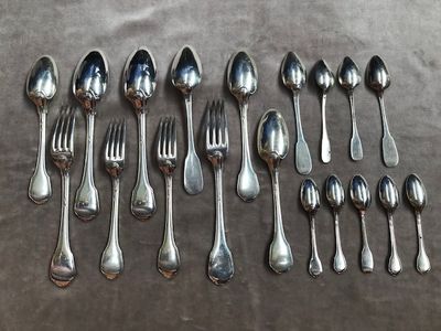 a lot of silver spoons and forks on the table