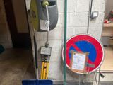 a picture of a garage with a toilet and a toilet paper dispenser