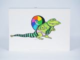 greeting card featuring a lizard holding a rainbow ball