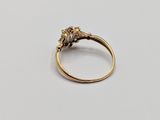a close up of a gold ring on a white surface