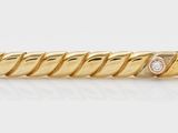 a yellow gold ring with a diamond set in the center