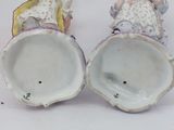 two figurines that are sitting next to each other