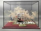 a display case with a model of a house in it