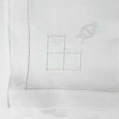 a close up of a white towel with a kite on it