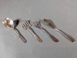 five spoons and a fork sitting on a table