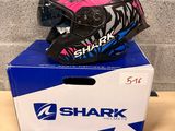 a box with a helmet on top of it next to a pair of gloves