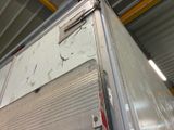 a large white truck parked inside of a building