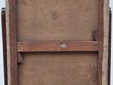 an old wooden easel with a painting on top of it