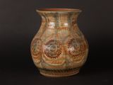 a vase that is sitting on a black surface