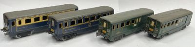 four toy train cars are lined up on a white surface
