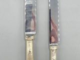 two knives that are sitting next to each other on a table