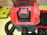 a red vacuum that is sitting on a counter