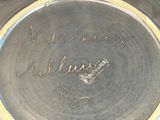 a close up of a silver plate with writing on it