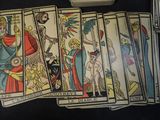 a lot of tarot cards that are sitting on a table
