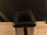an image of a toaster sitting on a wooden table