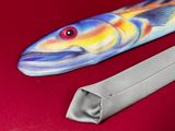 a tie that has a fish on it on a red surface