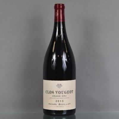 a bottle of red wine sitting on top of a glass table
