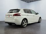 the rear end of a white car in a white room
