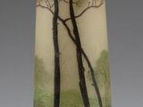 a vase with a painting of trees on it