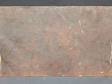 an old brown piece of paper with writing on it sitting on a table