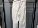 the white pants are hanging on a rack in the closet