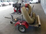 a small cart with a blower and a hose attached to it