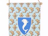 a blue and white wall hanging with a blue and white crest on it