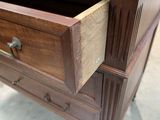 a wooden dresser with a drawer on top of it