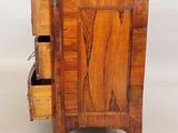 a small wooden cabinet with two drawers on it