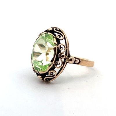 Gros plan sur une bague contenant une pierre verte