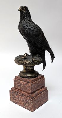a statue of a bird sitting on top of a pedestal