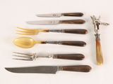 five different types of knives and a fork on a table