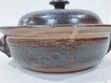 a brown pot with a lid sitting on a table