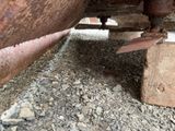 a close up of a rusted metal object on the ground