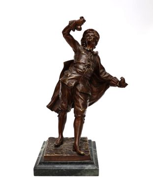 bronze statue of a man holding a bird on a marble base