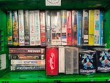 a green bin filled with various video games and dvds