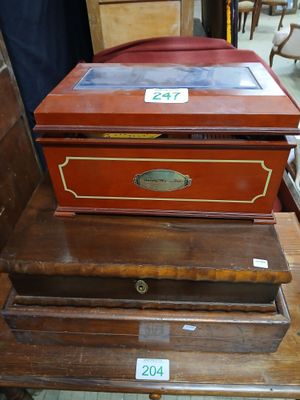 three wooden boxes stacked on top of each other on a table
