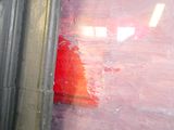 a red fire hydrant in the corner of a building