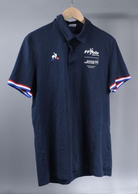 a blue polo shirt with a red, white and blue stripe around the collar