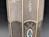 a vase that has a cross on the side of it